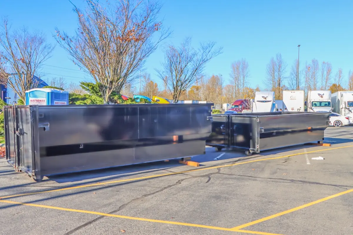 Professional dumpster rental service with roll-off container on residential driveway in Bensalem